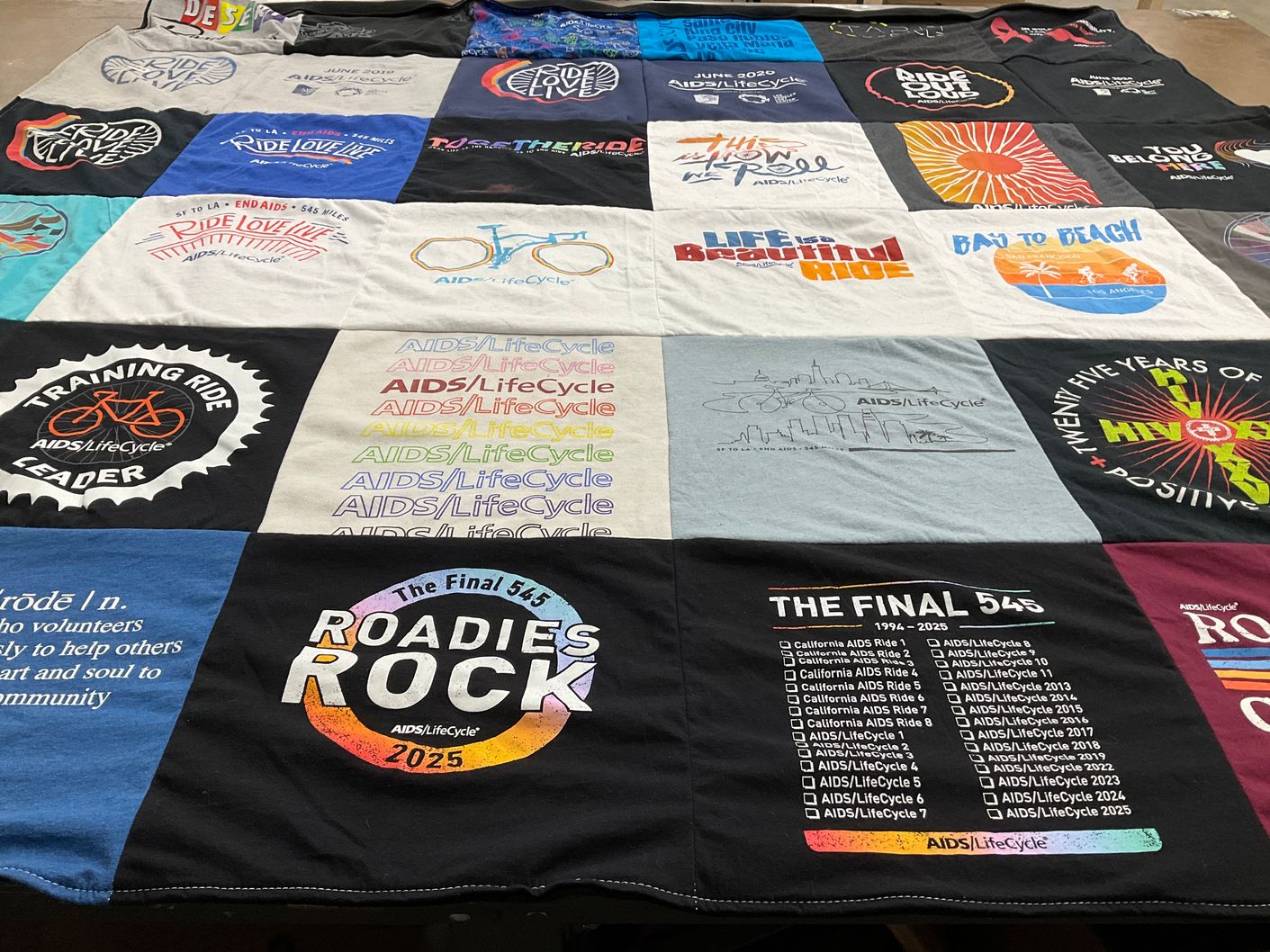 T-shirt quilt with cycling, community service themes by Colleen from CA