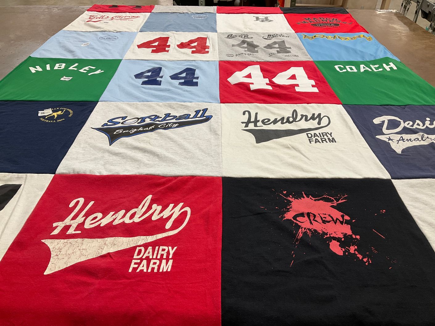 T-shirt quilt with softball, dairy farming themes by Julie from ID