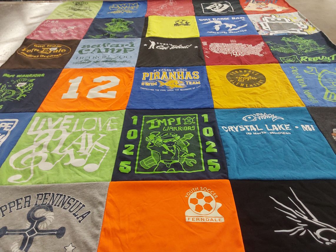 T-shirt quilt featuring impi warriors, piranhas swim team by Stacie from MI