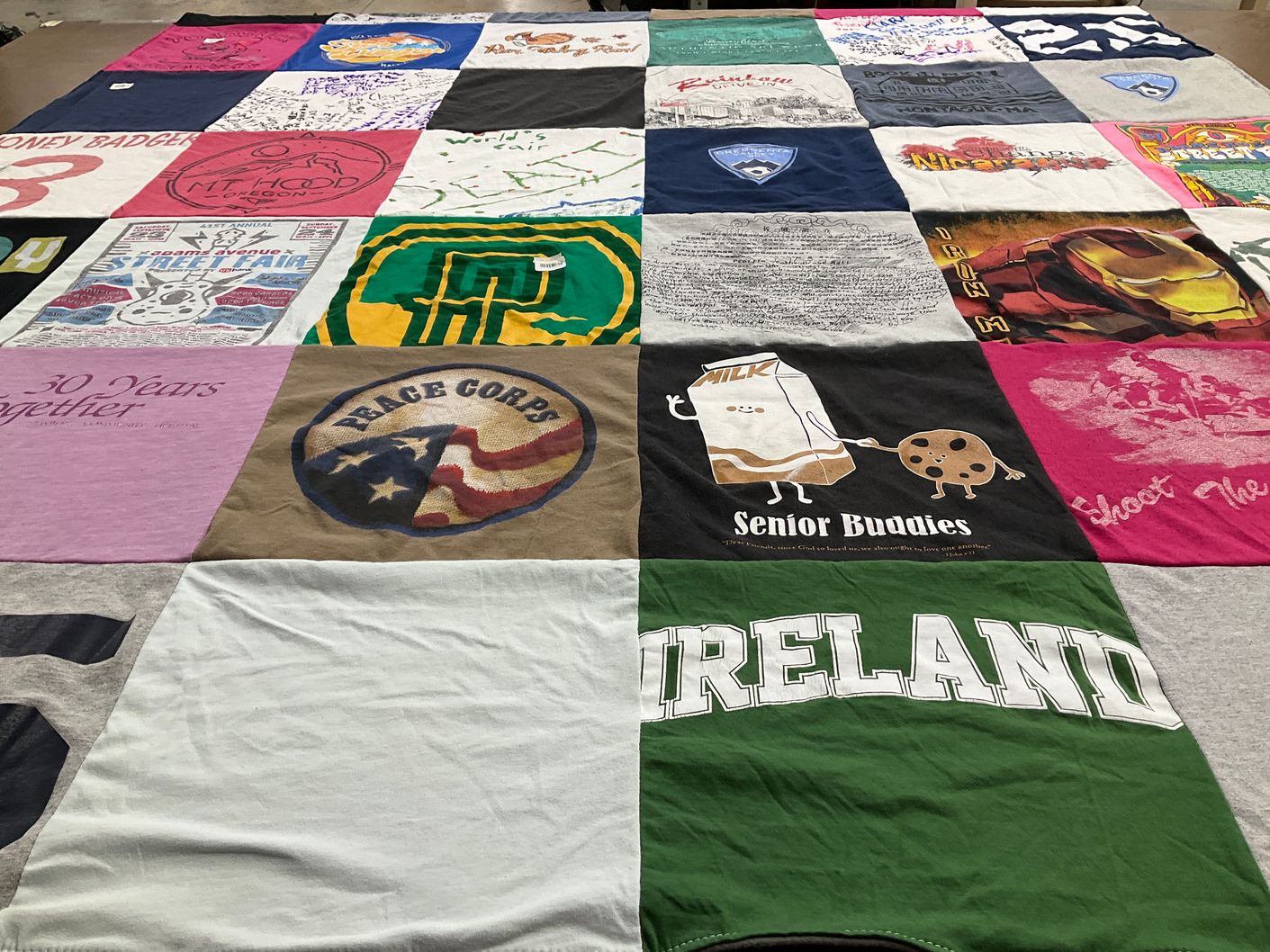 T-shirt quilt with community service, travel themes by Joy from CA
