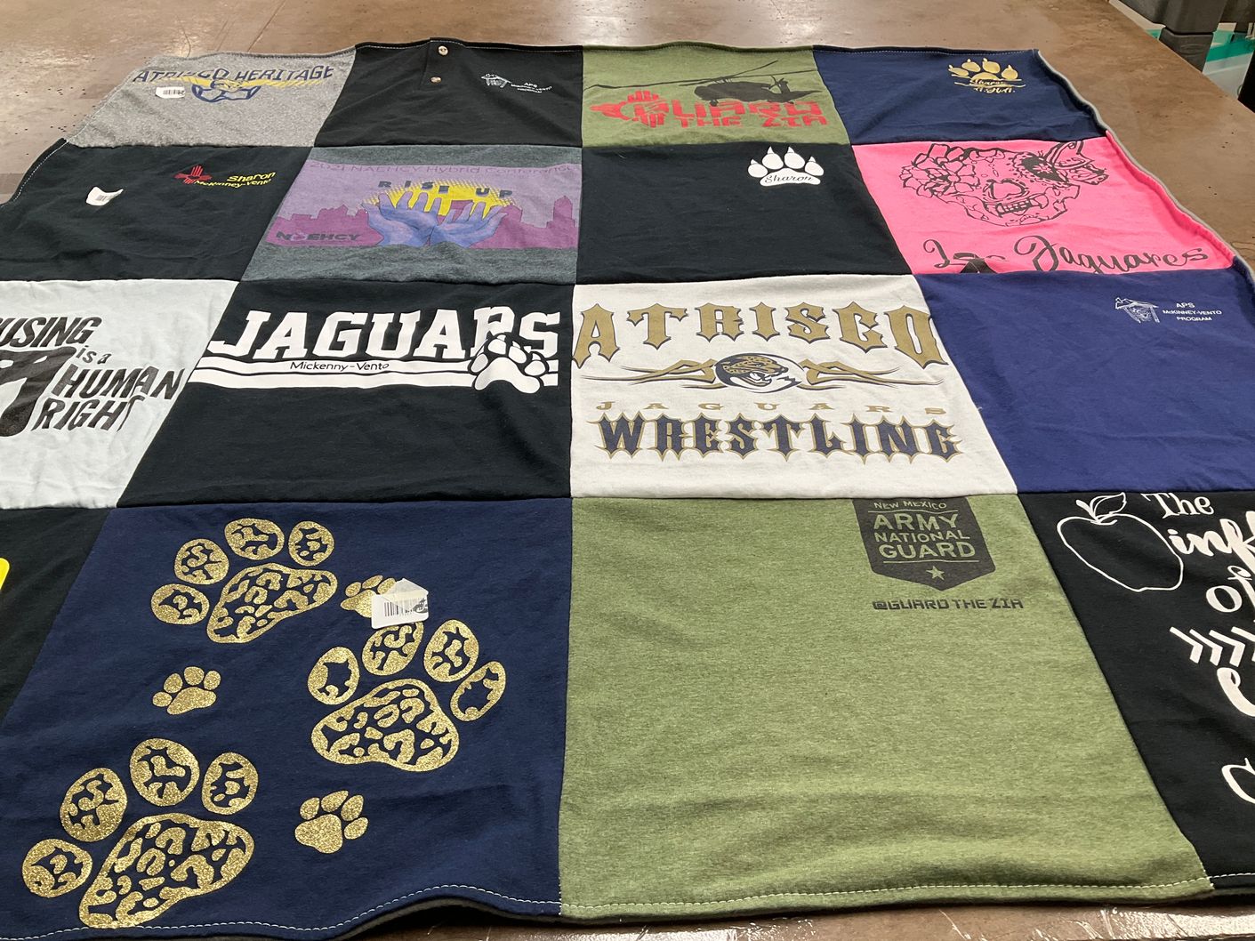 T-shirt quilt featuring atarisco heritage academy wrestling, mckinney-vento jaguars by Samantha from NM
