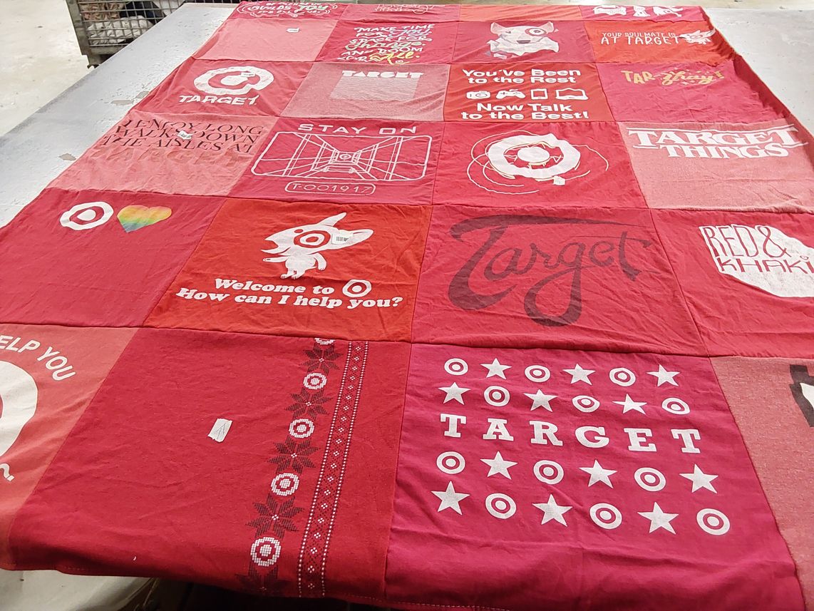 T-shirt quilt with shopping, retail themes by Betty from NJ