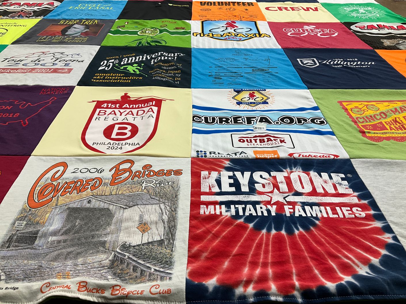 T-shirt quilt with cycling, fundraising themes by Laura from NJ