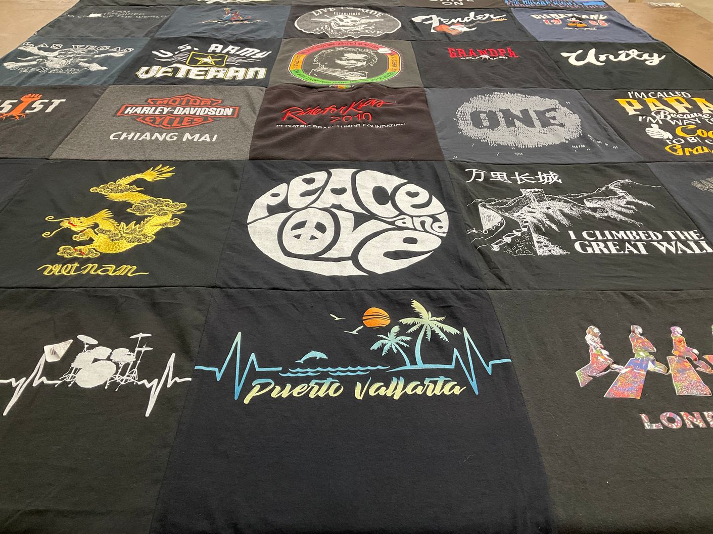 T-shirt quilt with travel, music themes by Eileen from CA