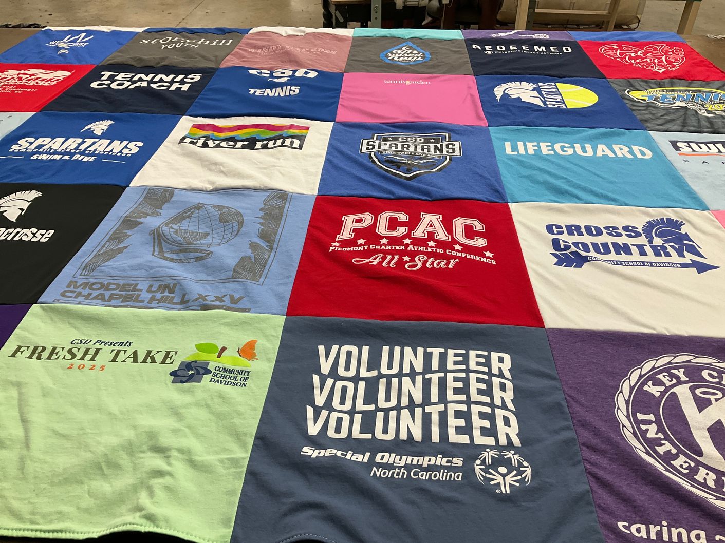 T-shirt quilt featuring charlotte country day school, charlotte spartans swimming and diving by Michelle from NC