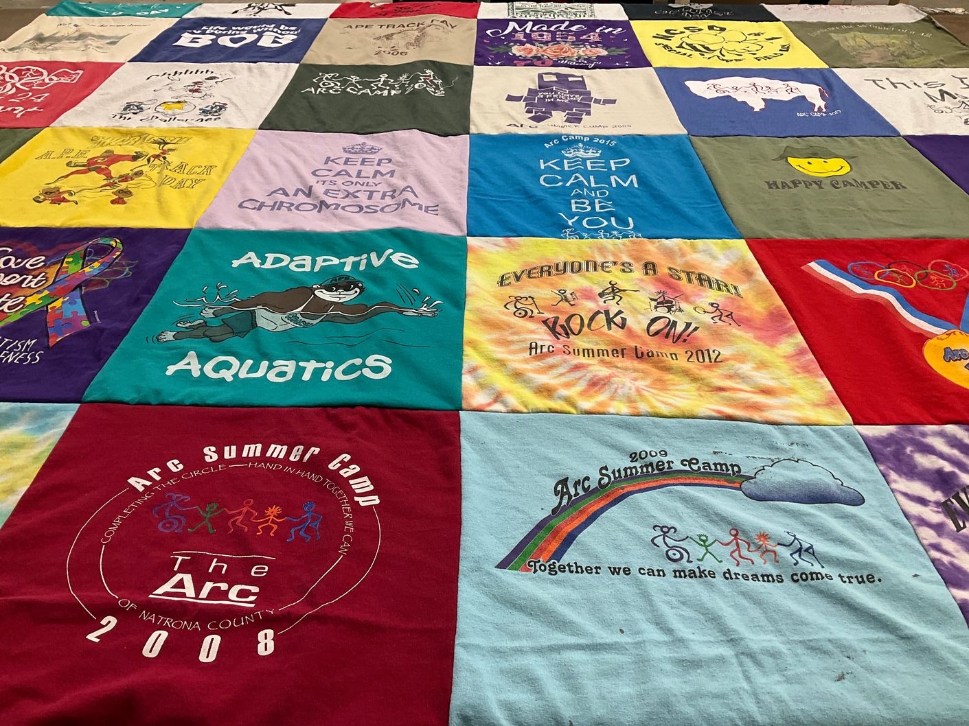 T-shirt quilt with camping, inclusivity themes by Susan from CO