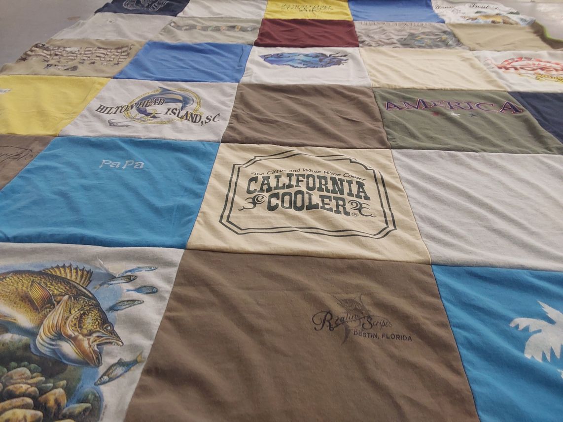 T-shirt quilt with fishing, traveling themes by Betty from MO