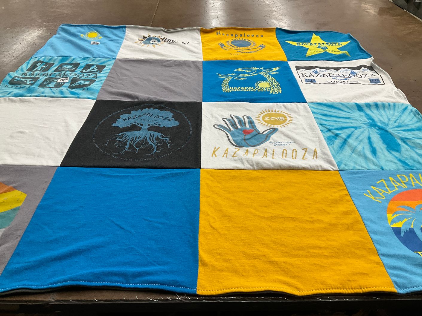 T-shirt quilt with festivals, community events themes by Rebecca from TX