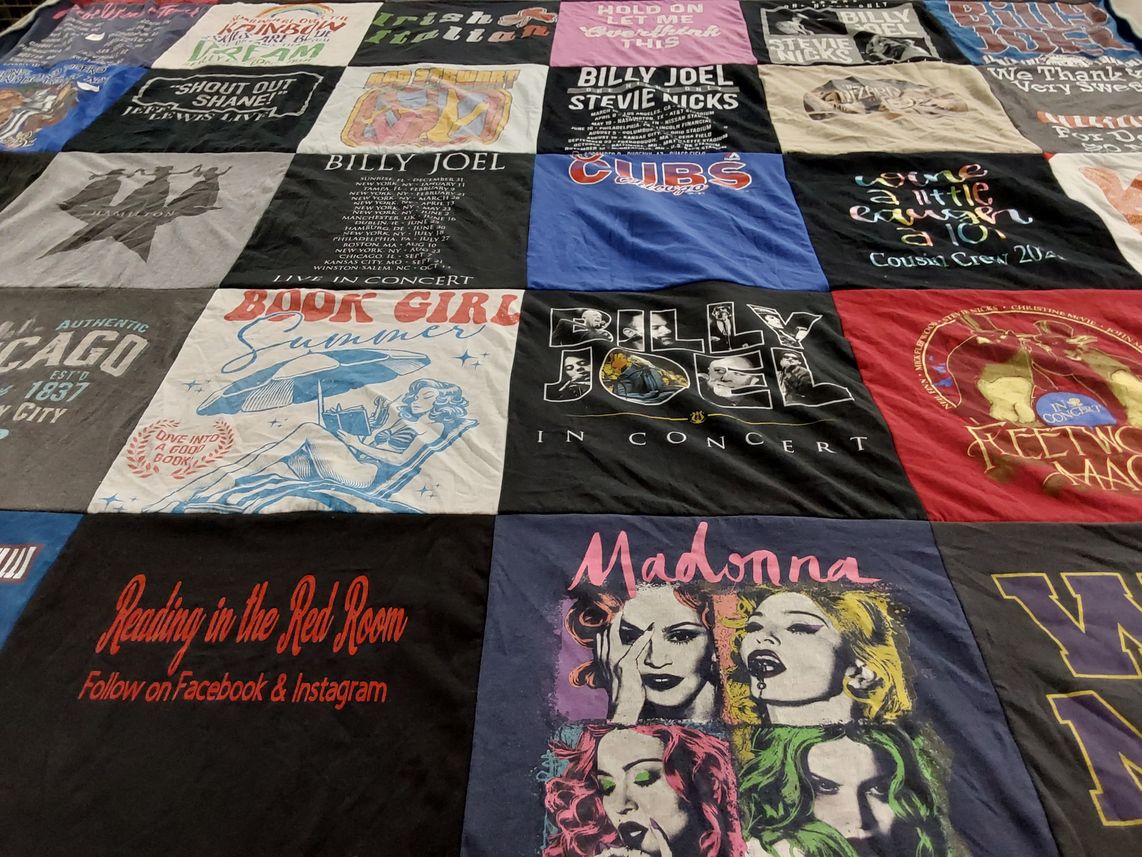 T-shirt quilt with music, reading themes by Laura from IA