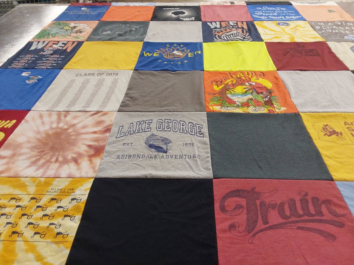 T-shirt quilt with travel, music themes by Elaine from AZ