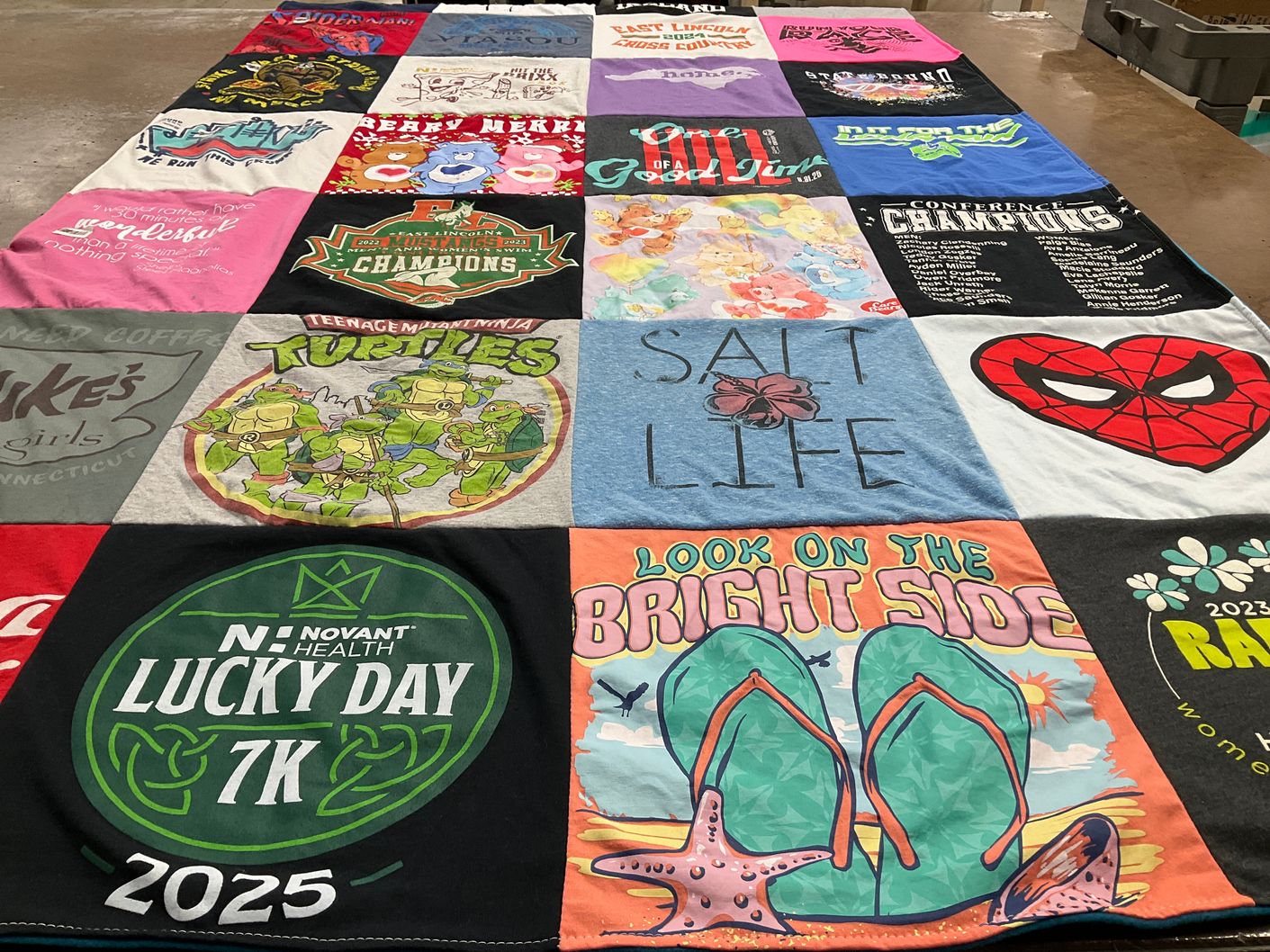 T-shirt quilt with running, community events themes by Amy from NC