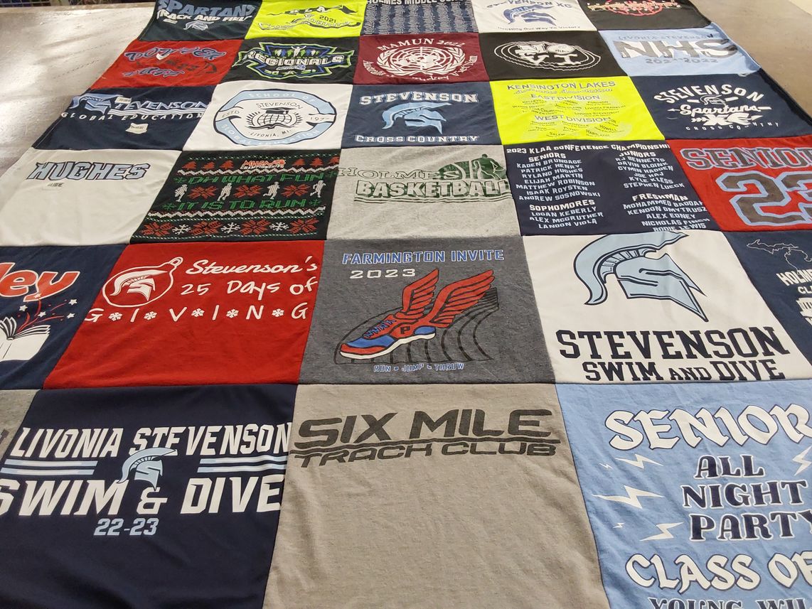 T-shirt quilt featuring livonia stevenson swim and dive, livonia stevenson cross country by ERIK from MI