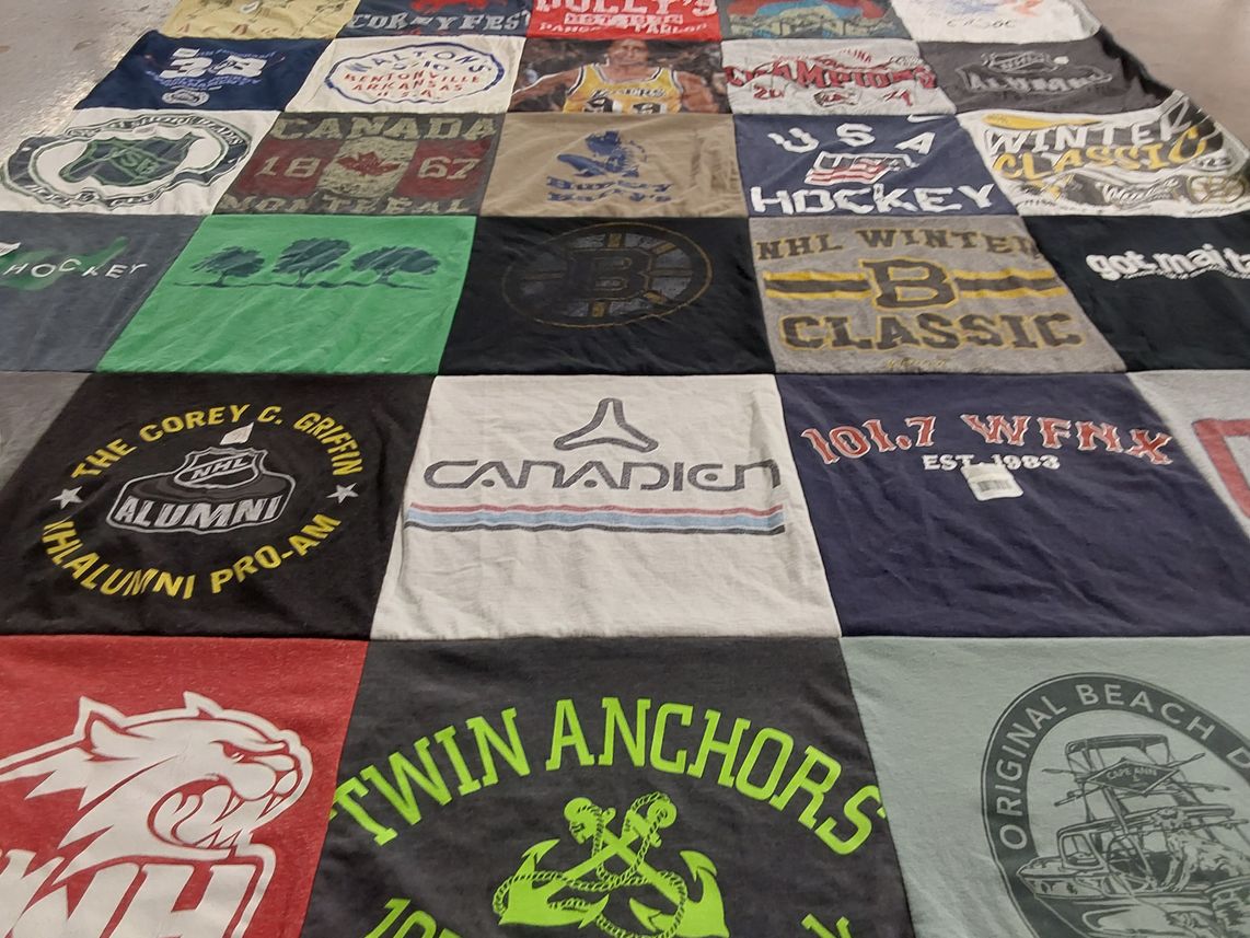 T-shirt quilt with hockey, music themes by Jackie from MA