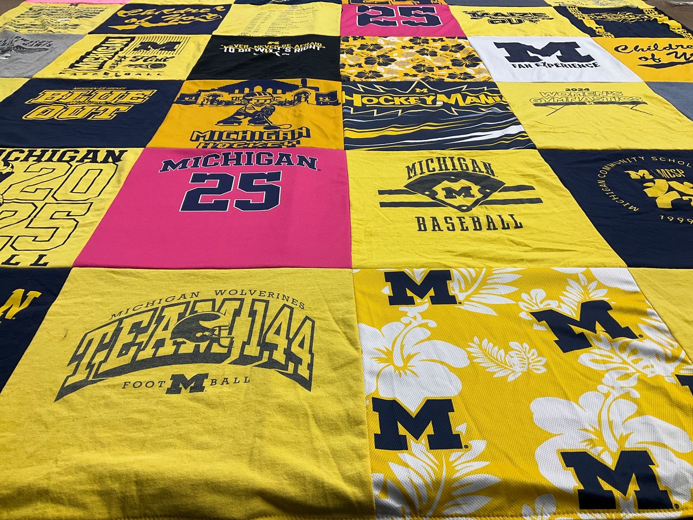 T-shirt quilt featuring university of michigan wolverines football, university of michigan hockey by Lia from MI