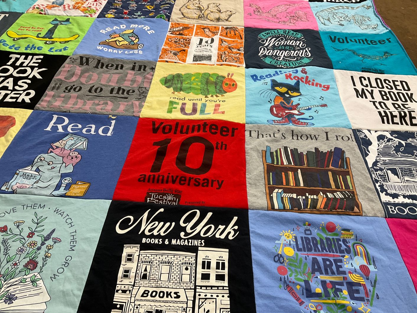 T-shirt quilt with reading, volunteering themes by Sara from NC