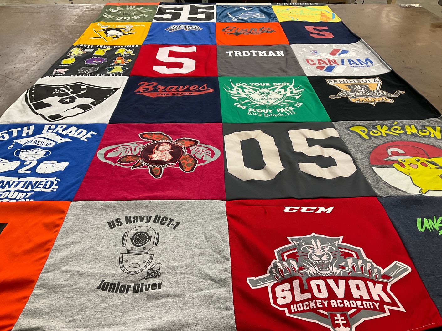T-shirt quilt with hockey, scouting themes by Susan from VA