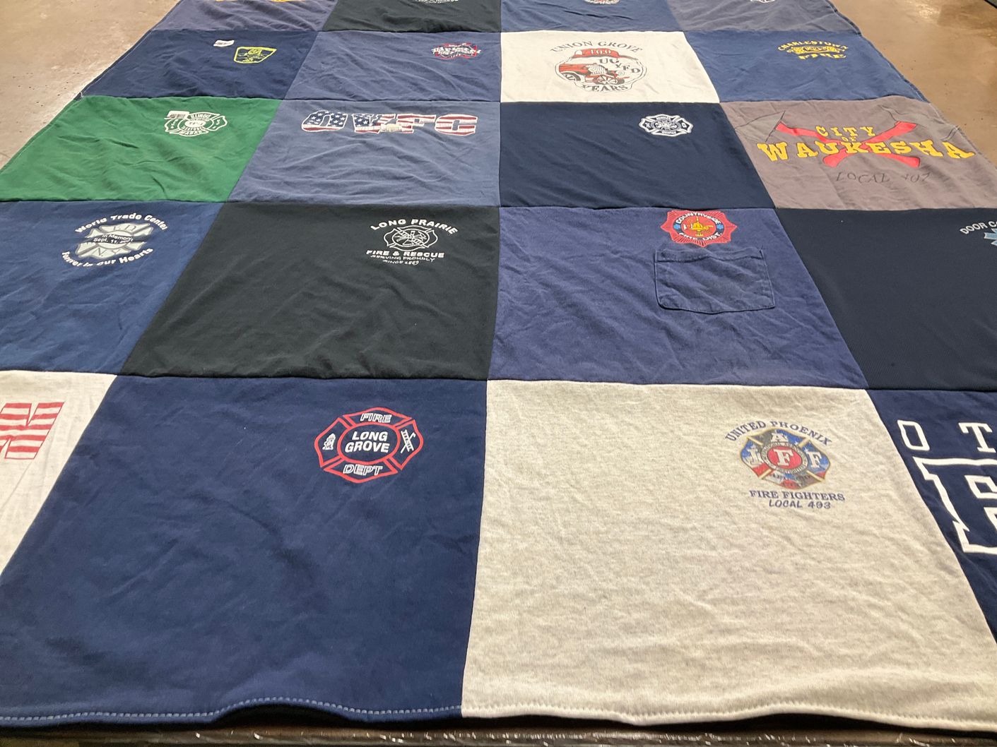T-shirt quilt with firefighting, community service themes by Liz from WI