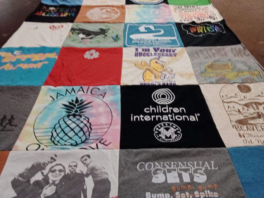 T-shirt quilt with travel, adventure themes by Erin from MT