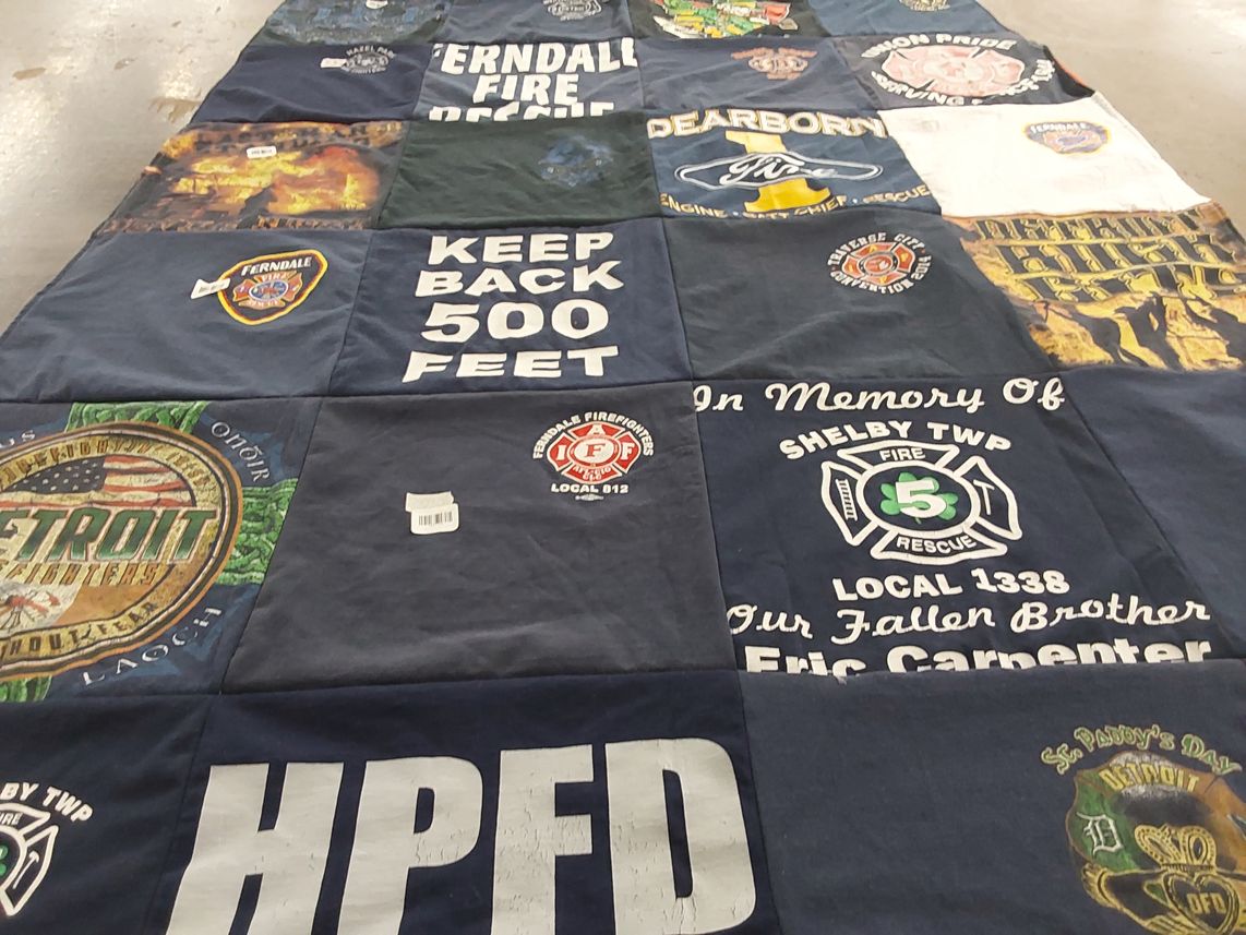 T-shirt quilt with firefighting, community service themes by Patti from MI