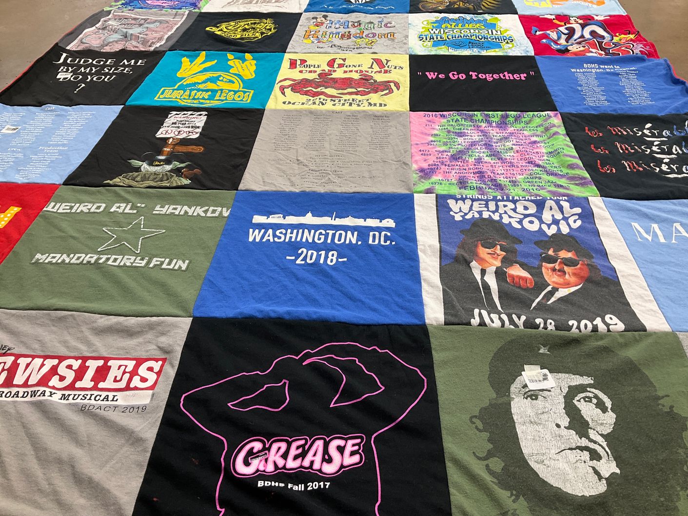 T-shirt quilt with musicals, comedy themes by Dionette from WI