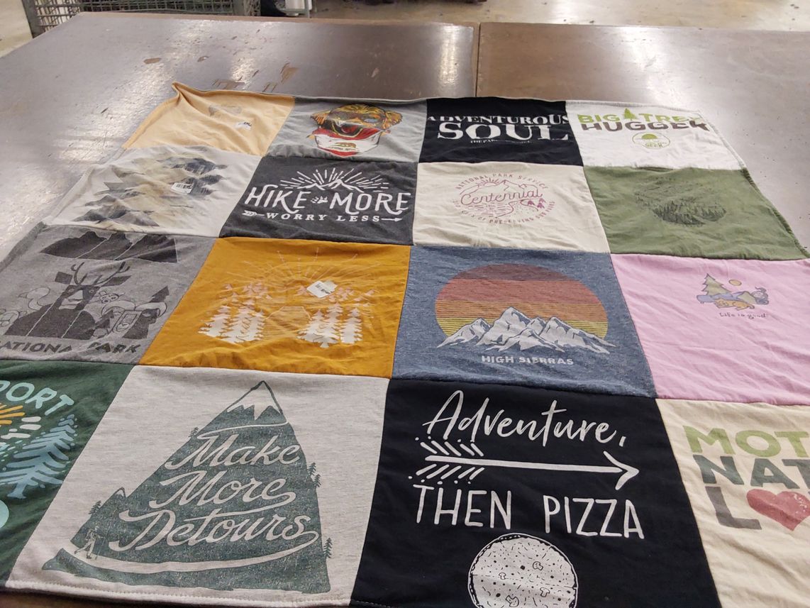 T-shirt quilt with hiking, outdoors themes by Genevieve from CA
