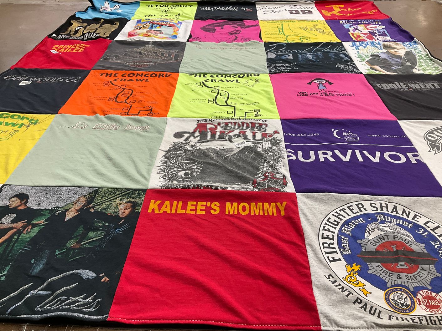 T-shirt quilt with community events, family themes by Sandy from MN