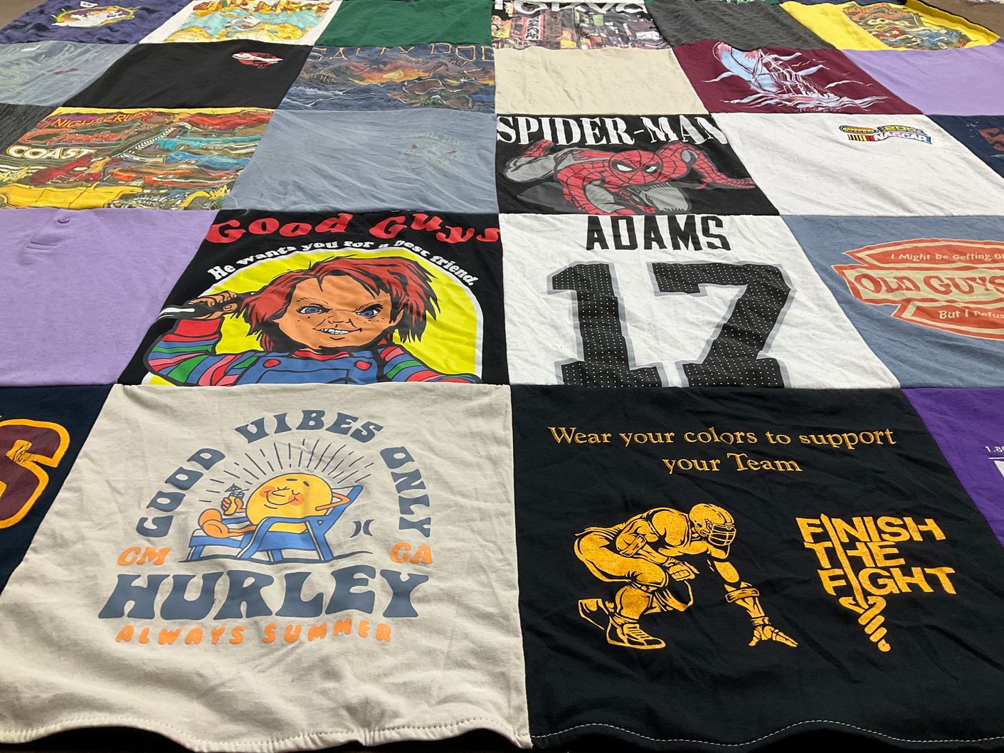 T-shirt quilt with sports, horror themes by Doretta from NC