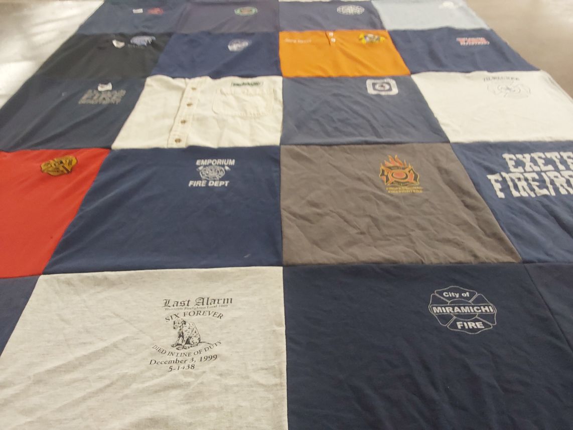 T-shirt quilt with firefighting, community service themes by Liz from WI