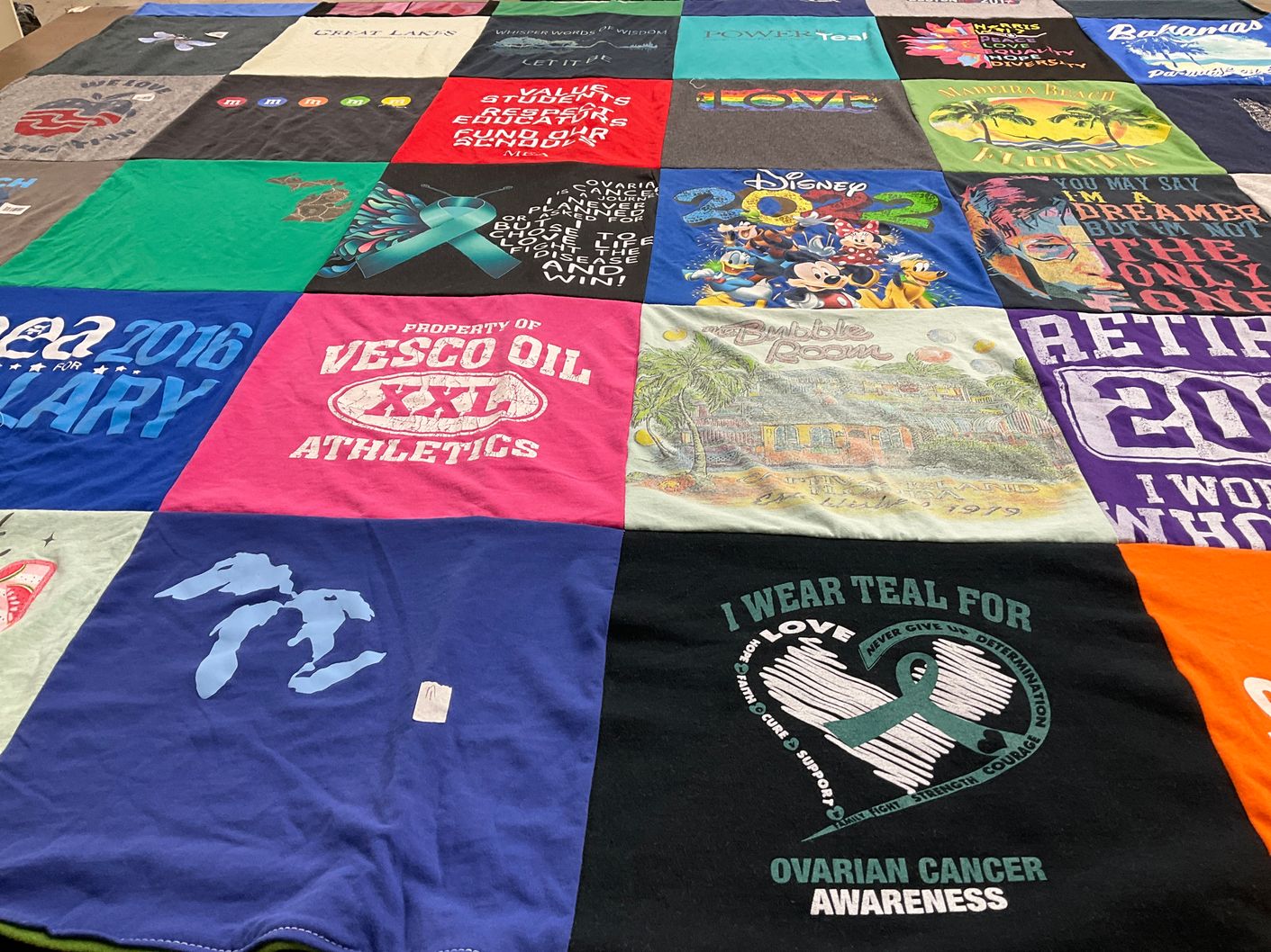 T-shirt quilt with cancer awareness, education themes by Linda from MI