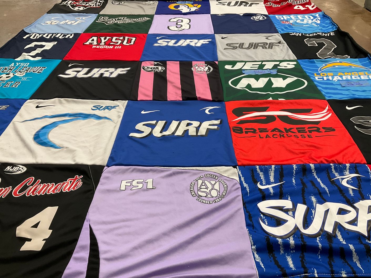 T-shirt quilt with soccer, lacrosse themes by Kristin from CA