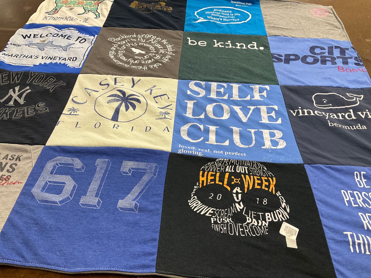 T-shirt quilt with self care, community themes by Elizabeth from PA