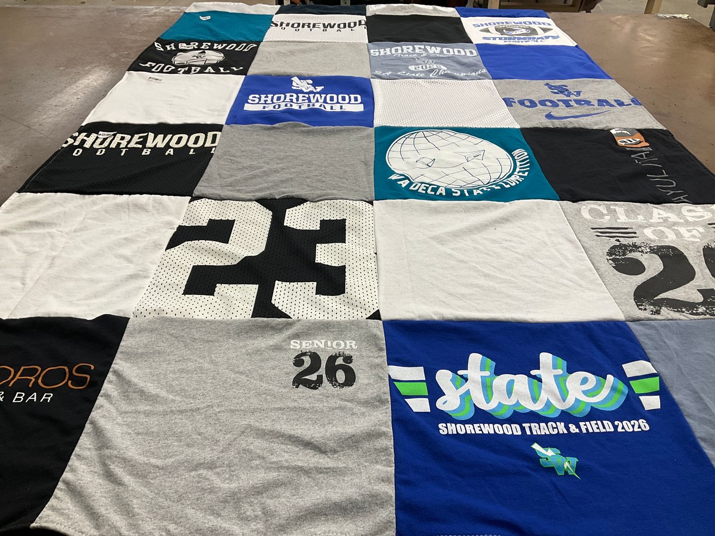 T-shirt quilt featuring shorewood football, shorewood track & field by Johanna from WA