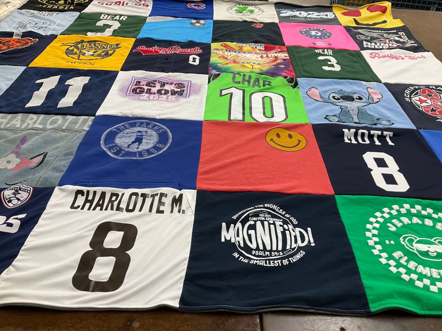 T-shirt quilt with sports, community events themes by Angelina from CA