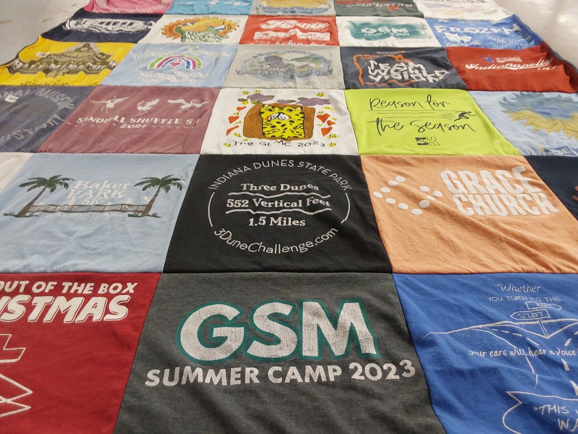 T-shirt quilt with running, camping themes by kimbra from IN