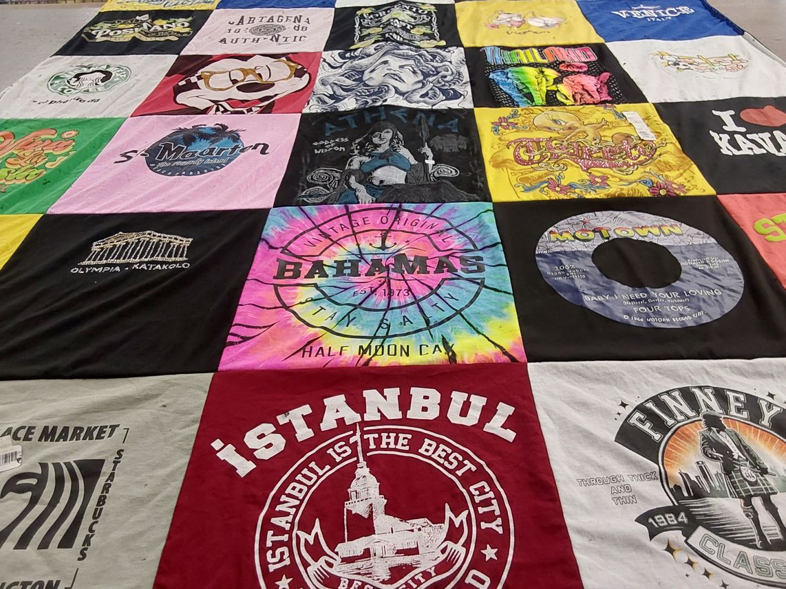 T-shirt quilt with travel, music themes by Allison from NV