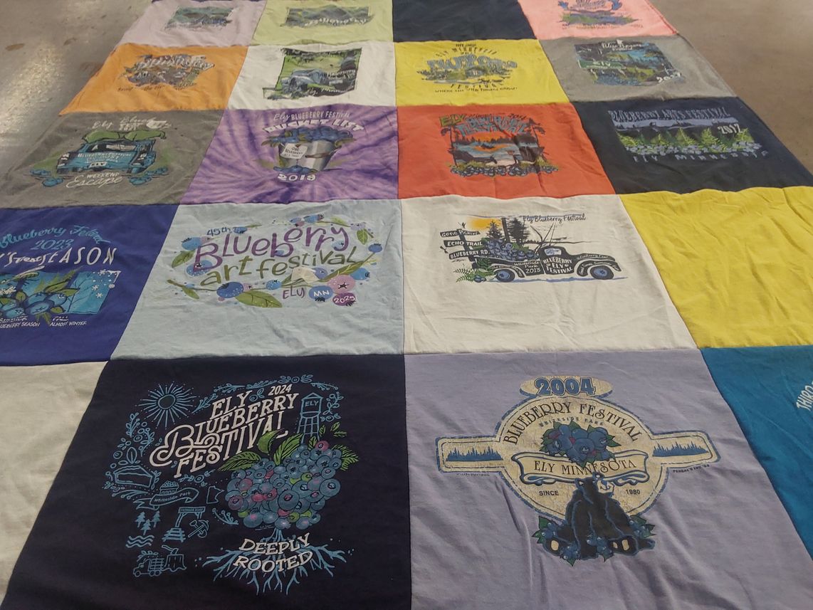 T-shirt quilt with local festivals, art events themes by Megan from WI