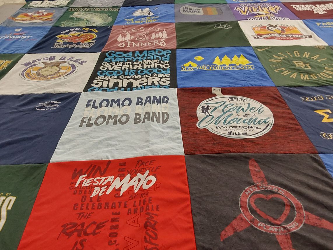 T-shirt quilt with running, music themes by Emily from TX