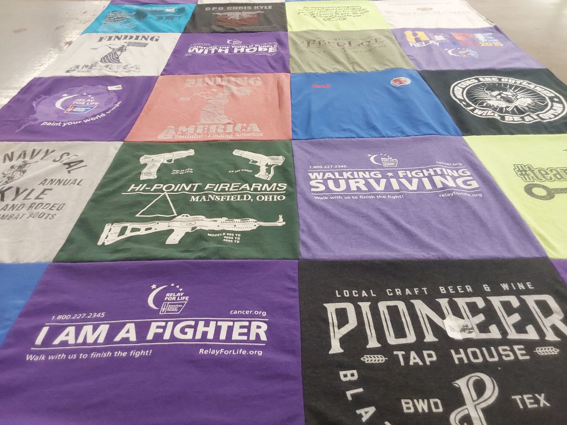 T-shirt quilt with cancer awareness, community events themes by Meichele from TX