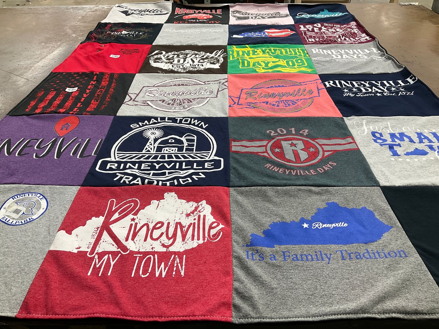 T-shirt quilt with community events, local pride themes by Ginger from KY