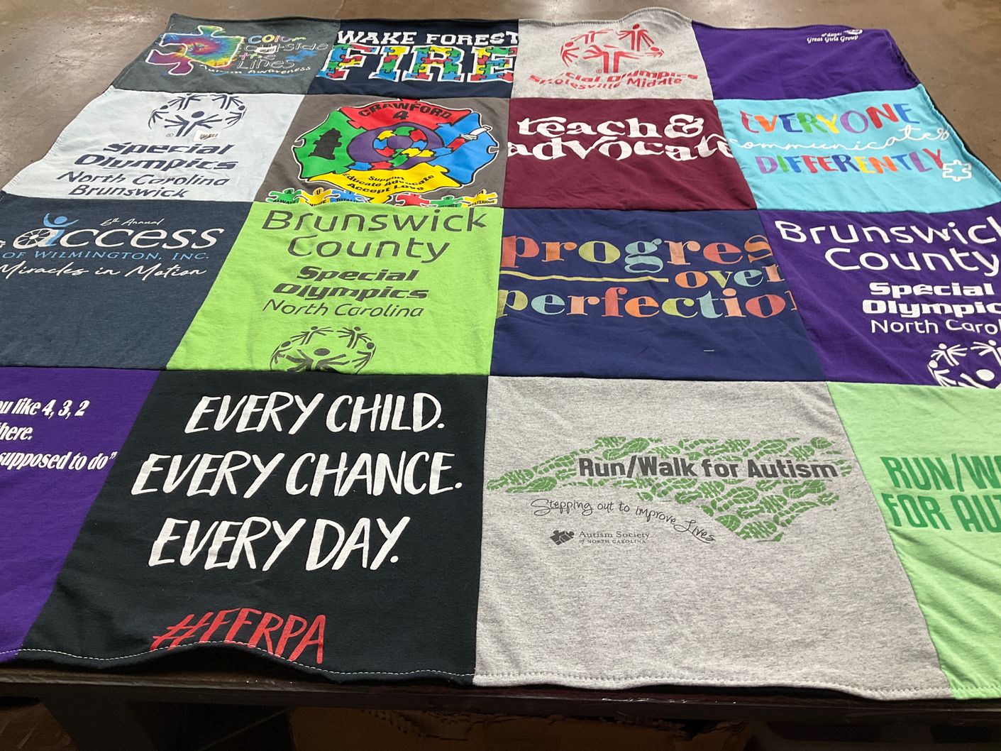 T-shirt quilt with autism advocacy, special olympics themes by Corinne from NC