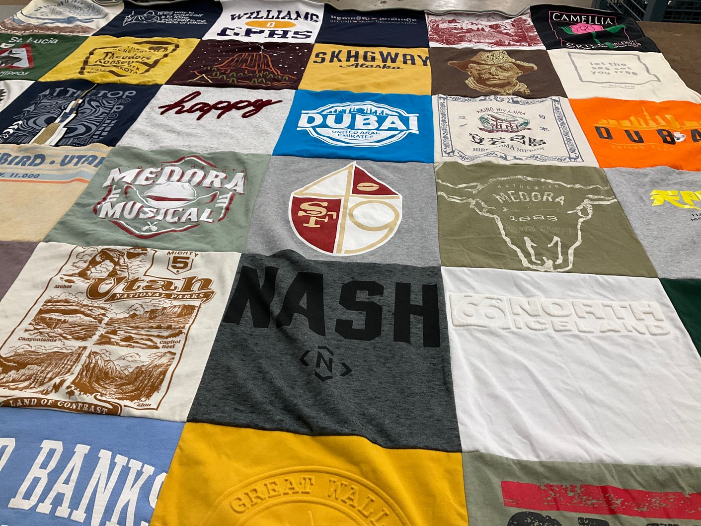 T-shirt quilt with travel, music themes by Toni from UT