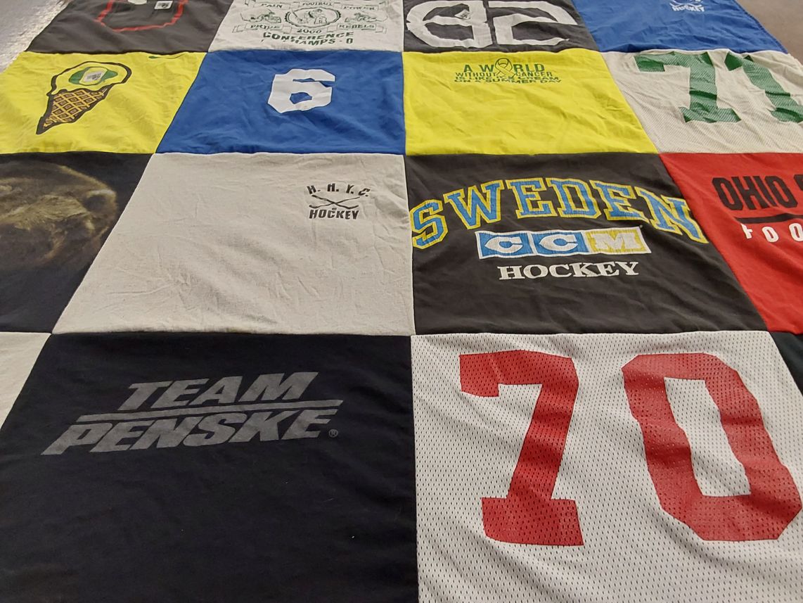 T-shirt quilt with hockey, football themes by Amanda from IL