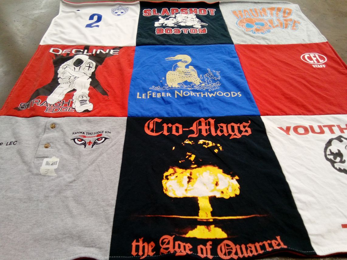T-shirt quilt with music, hockey themes by Anna from WI