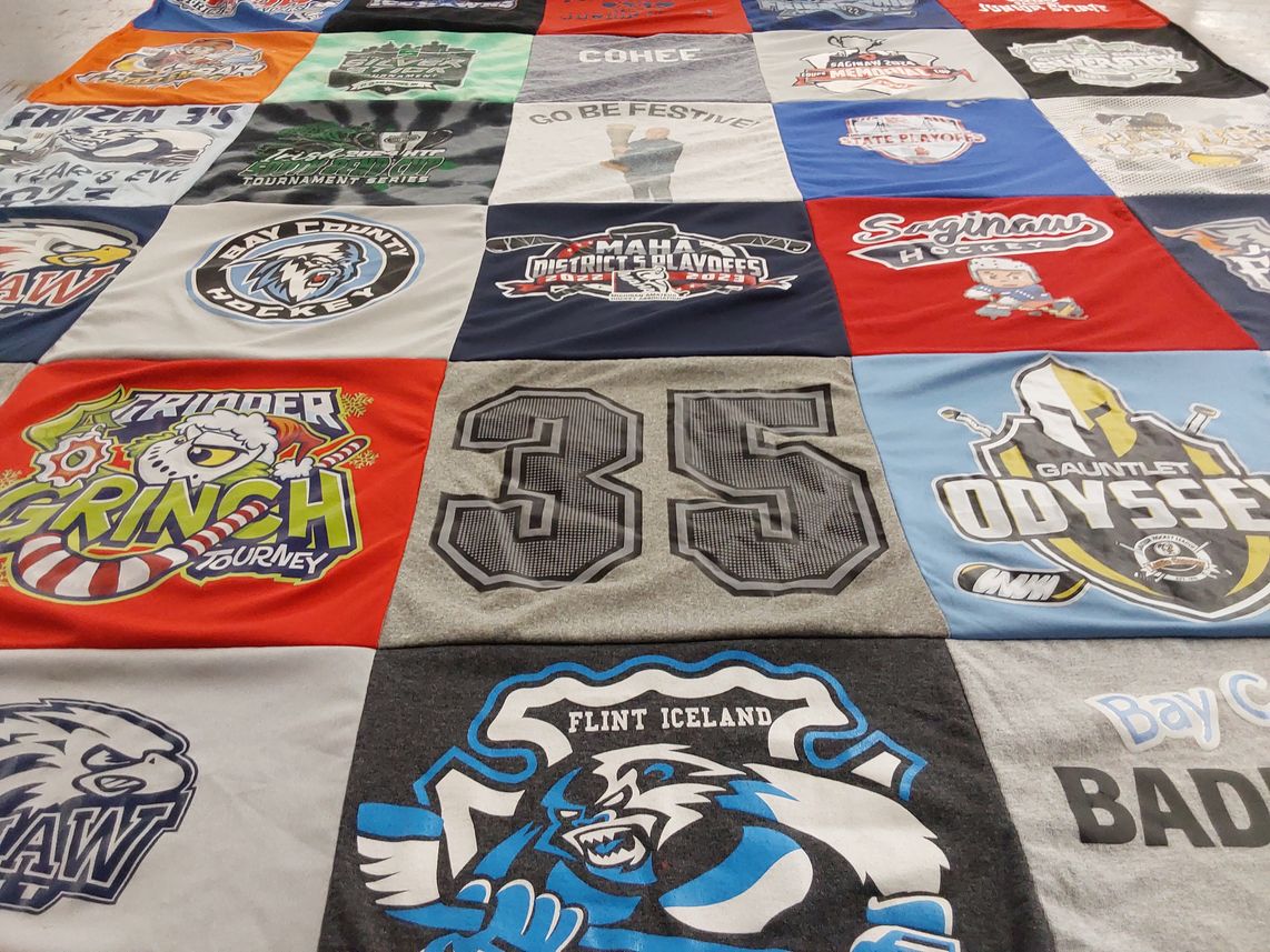 T-shirt quilt with hockey, tournaments themes by Tara from MI