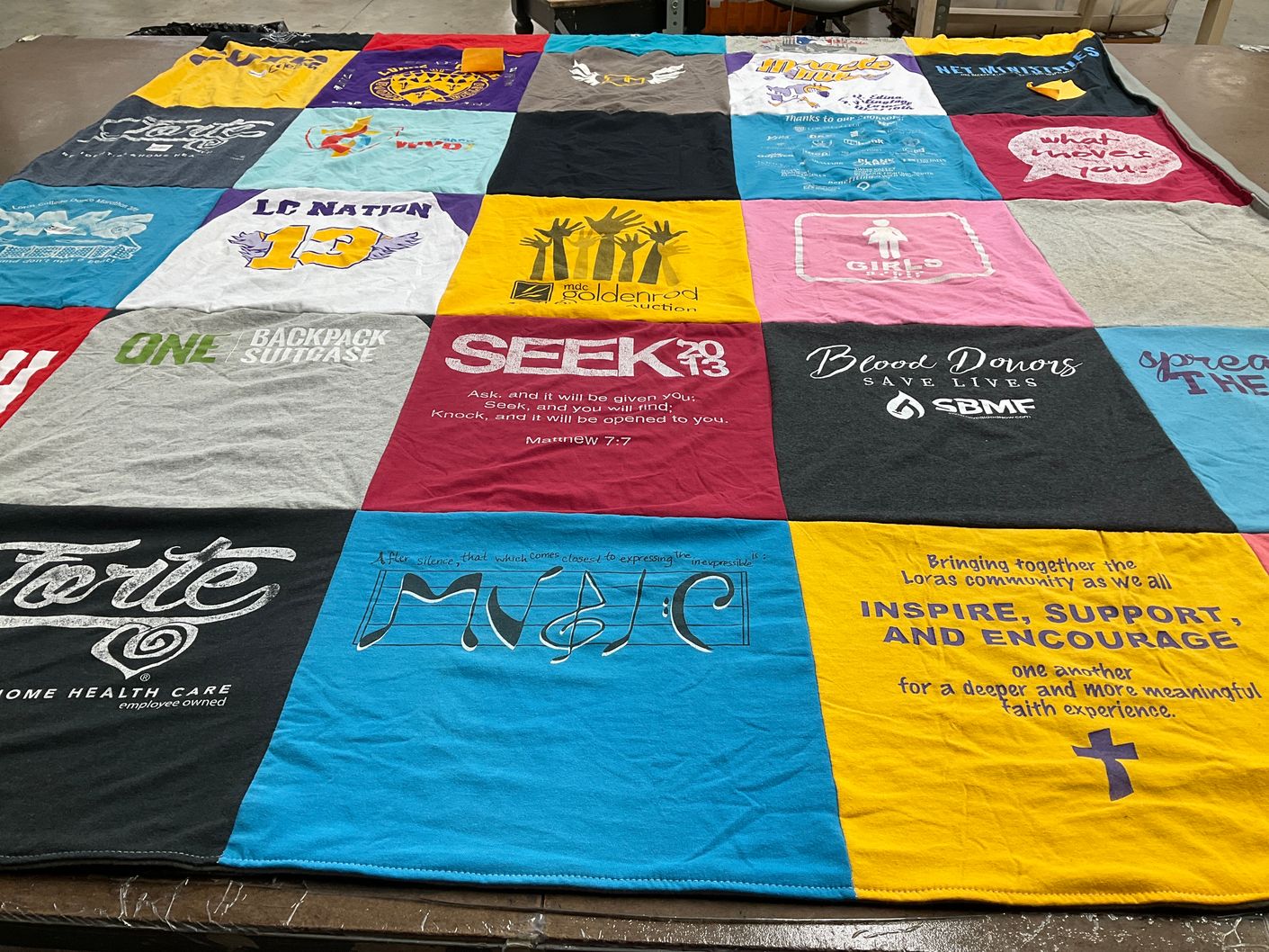 T-shirt quilt with community support, donation themes by Ryenn from IN