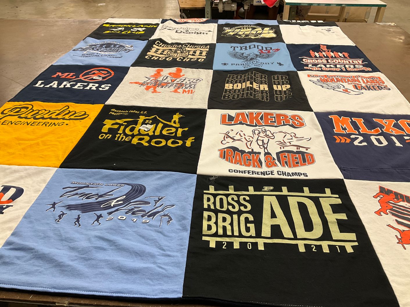 T-shirt quilt featuring lakers track and field, mountain lake lakers by Rebecca from NJ