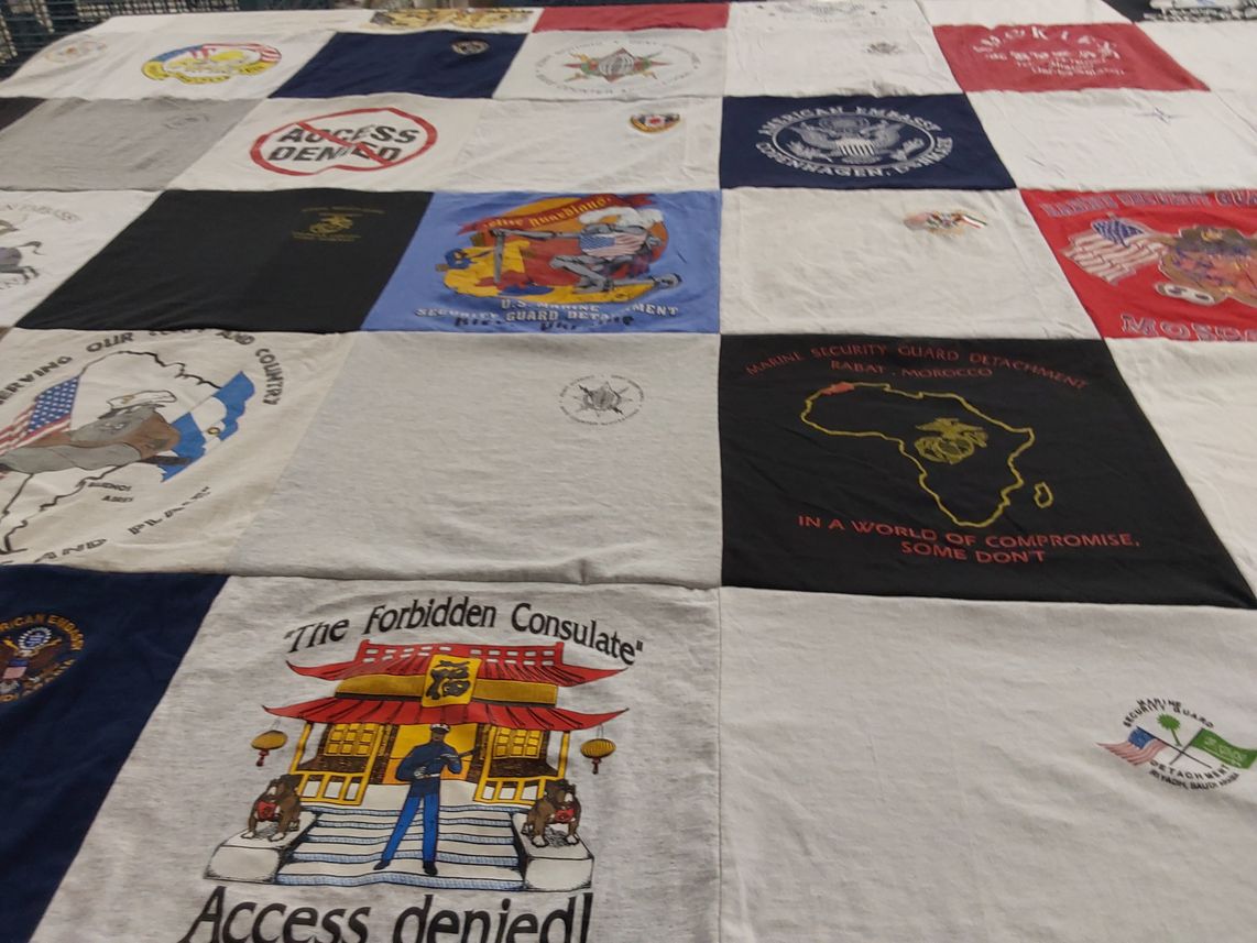 T-shirt quilt with military, diplomacy themes by Camille from VA