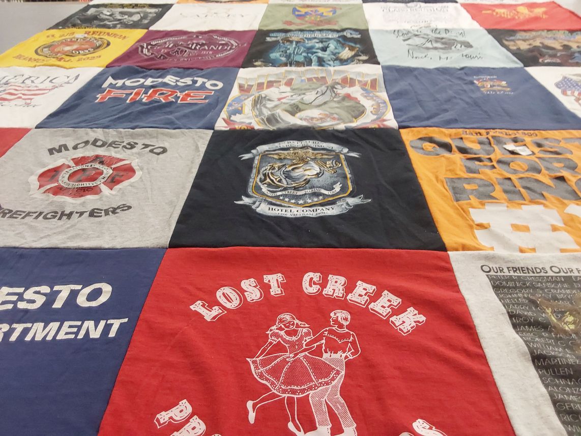 T-shirt quilt with firefighting, community support themes by Jackie from WA
