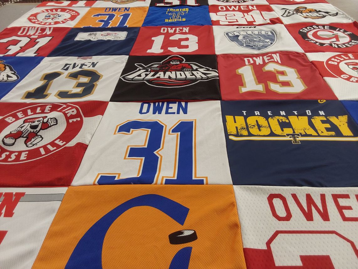 T-shirt quilt with hockey, lacrosse themes by Bridgette from MI