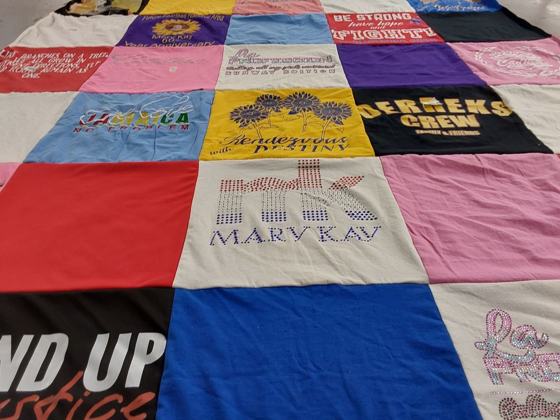 T-shirt quilt with community, empowerment themes by Gwendolyn from AZ